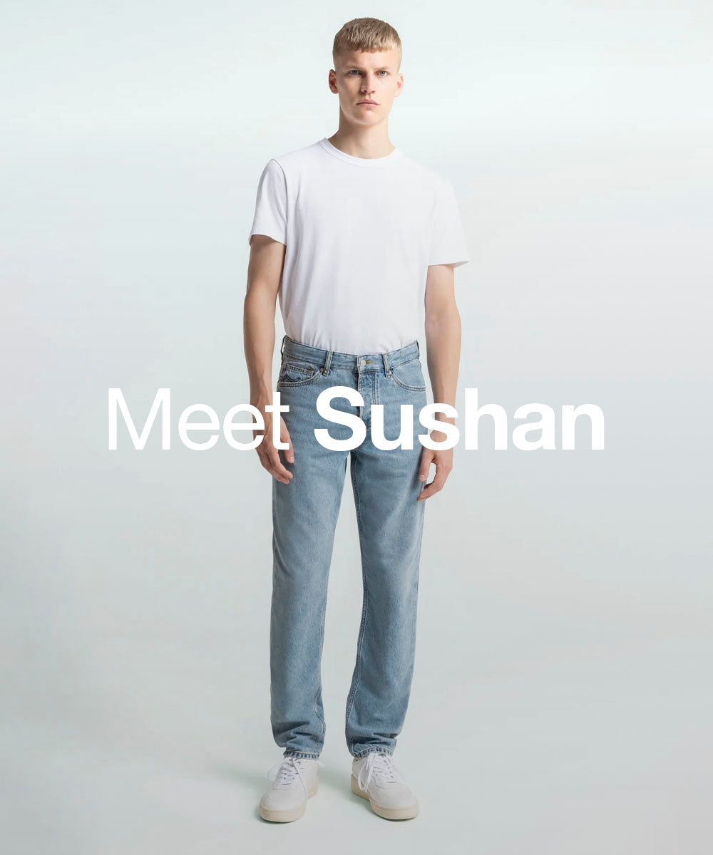 Person wearing a white t-shirt and light blue jeans on a plain background with 'Meet Sushan' text.